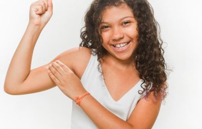 happy girl flexing her muscles